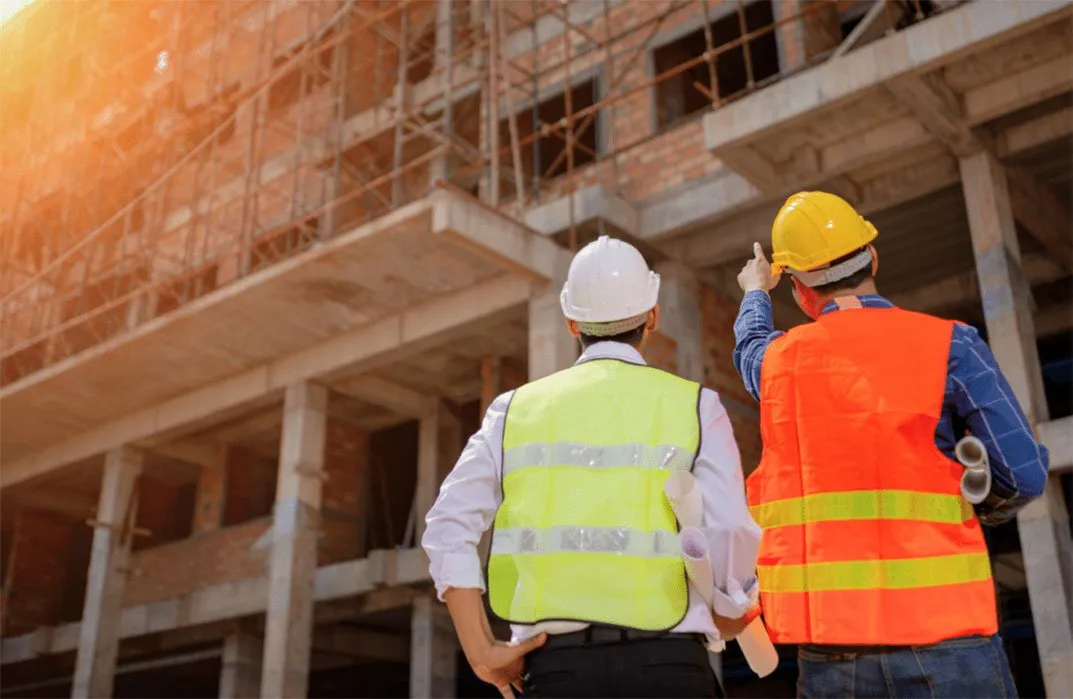 Two engineers in safety vests inspecting a building under construction – quality control in Bhopal