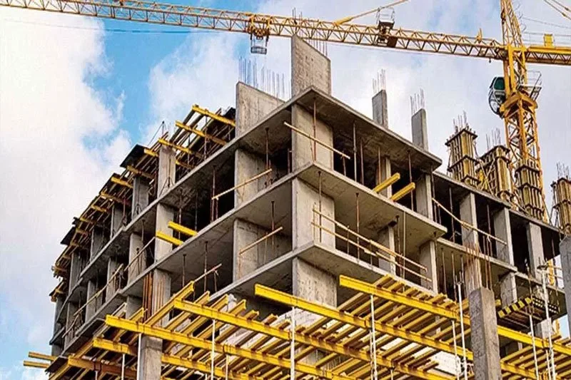 High-rise building under construction with tower cranes